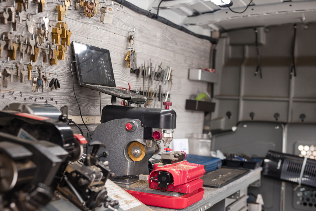 Key-cutting machine and a wall of key blanks inside the A Lock & Key Center shop